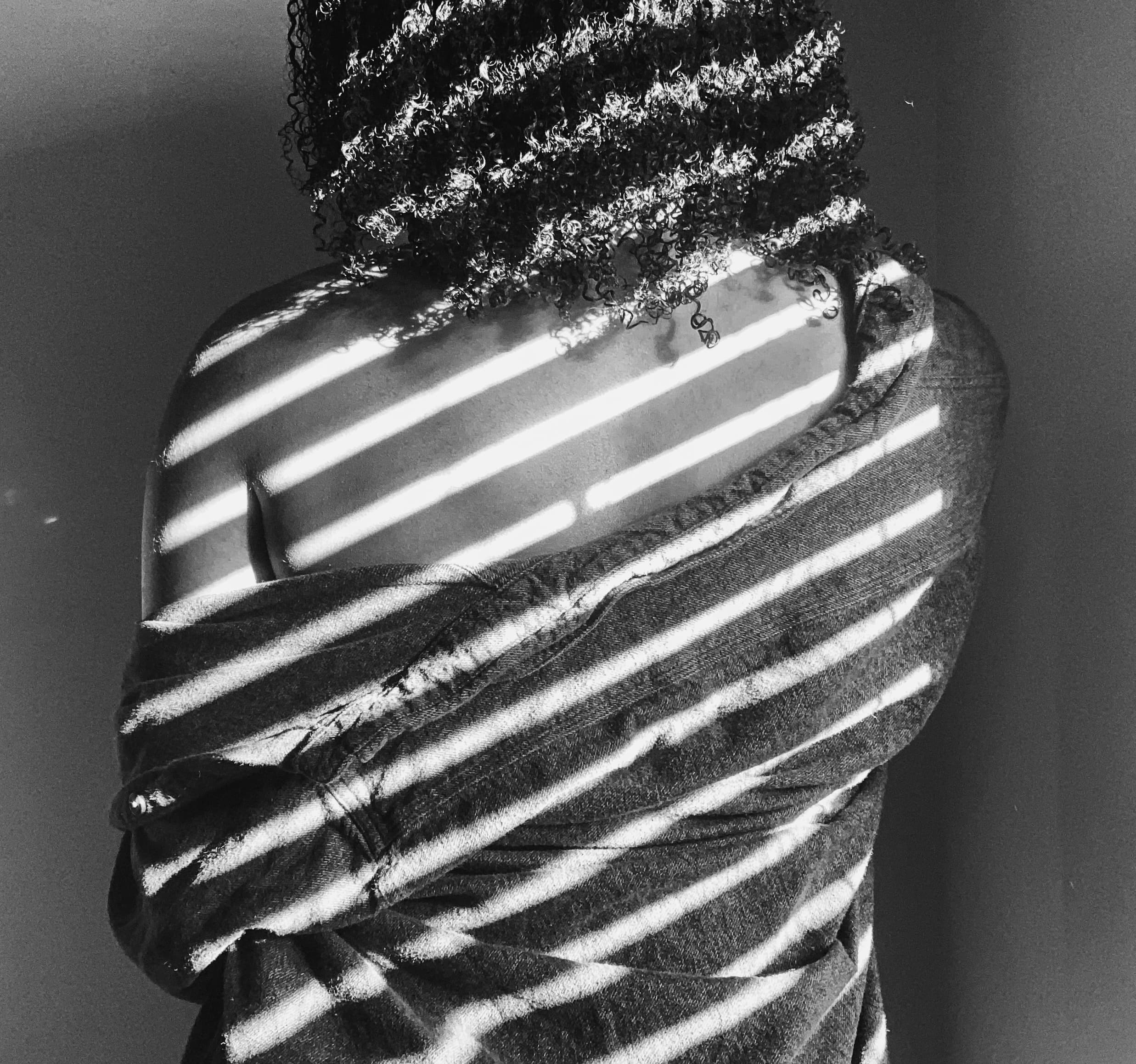 Black-and-white portrait of Randy Emillio in striped light