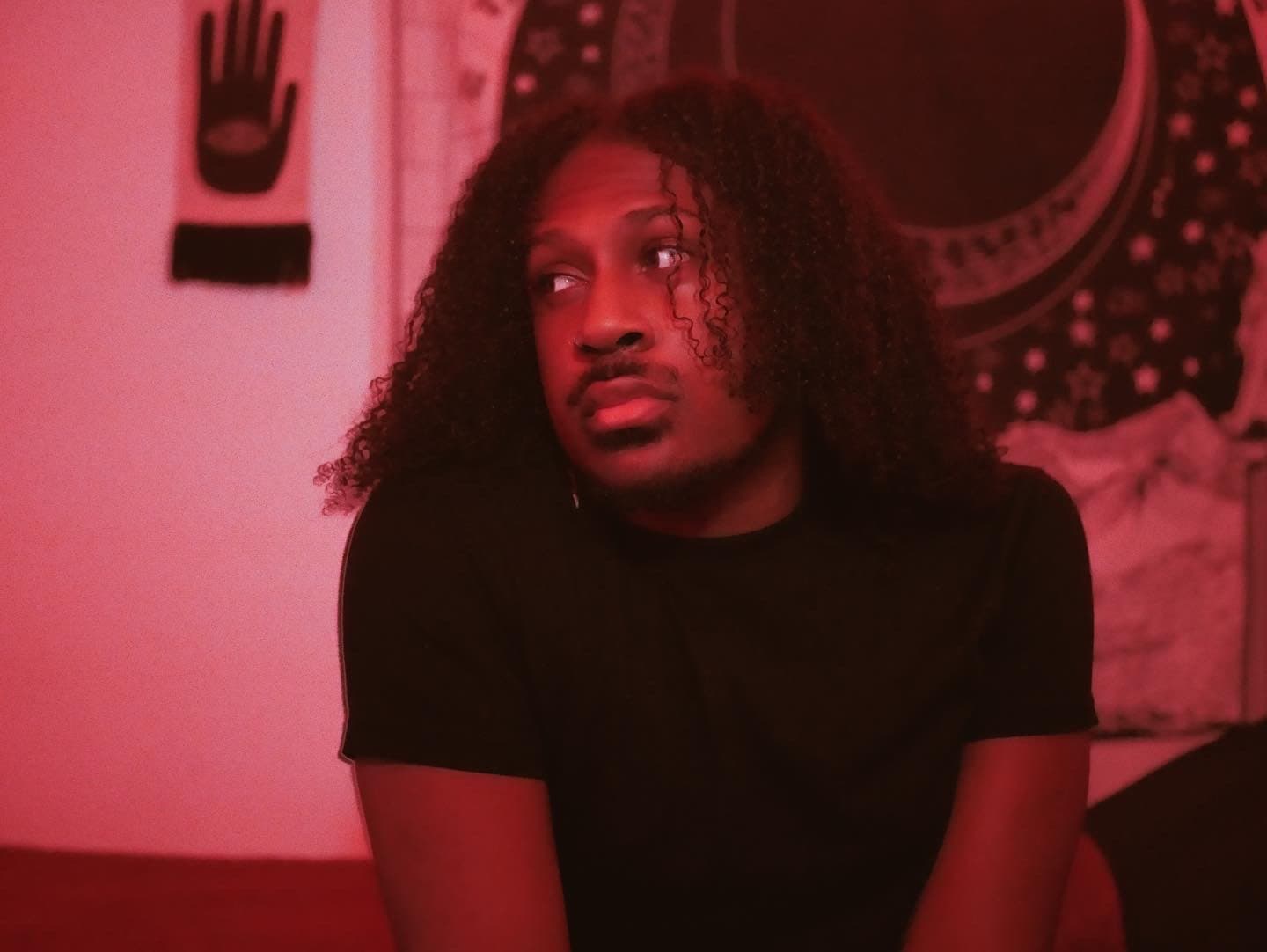 Randy Emillio in a red-lit room